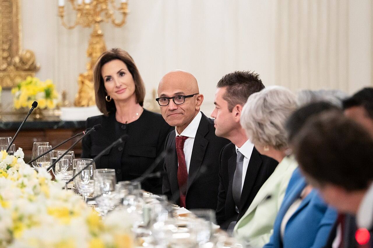 Satya Nadella, con gafas y corbata granate, sentado a la mesa durante una cena de la Casa Blanca con líderes empresariales y tecnológicos, el 4 de septiembre de 2025