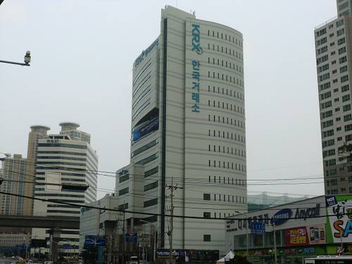 Torre del Korea Exchange (KRX), la bolsa surcoreana, en Busan, con el rótulo KRX y el texto coreano 한국거래소 en la fachada, sin personas en el encuadre